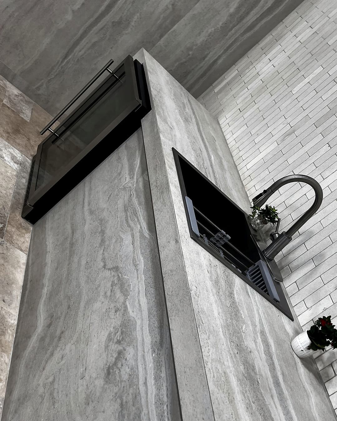 Kitchen island with marble stone cladding